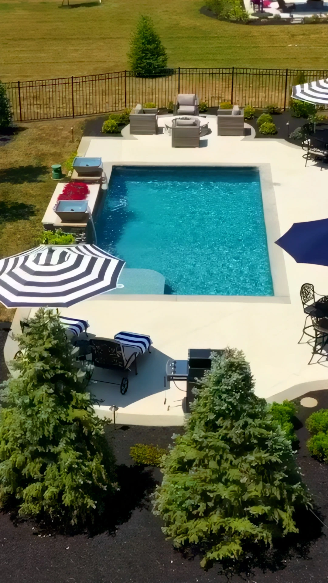 Rectangular pool with bullnose travertine coping on a sun-exposed Marietta, GA backyard