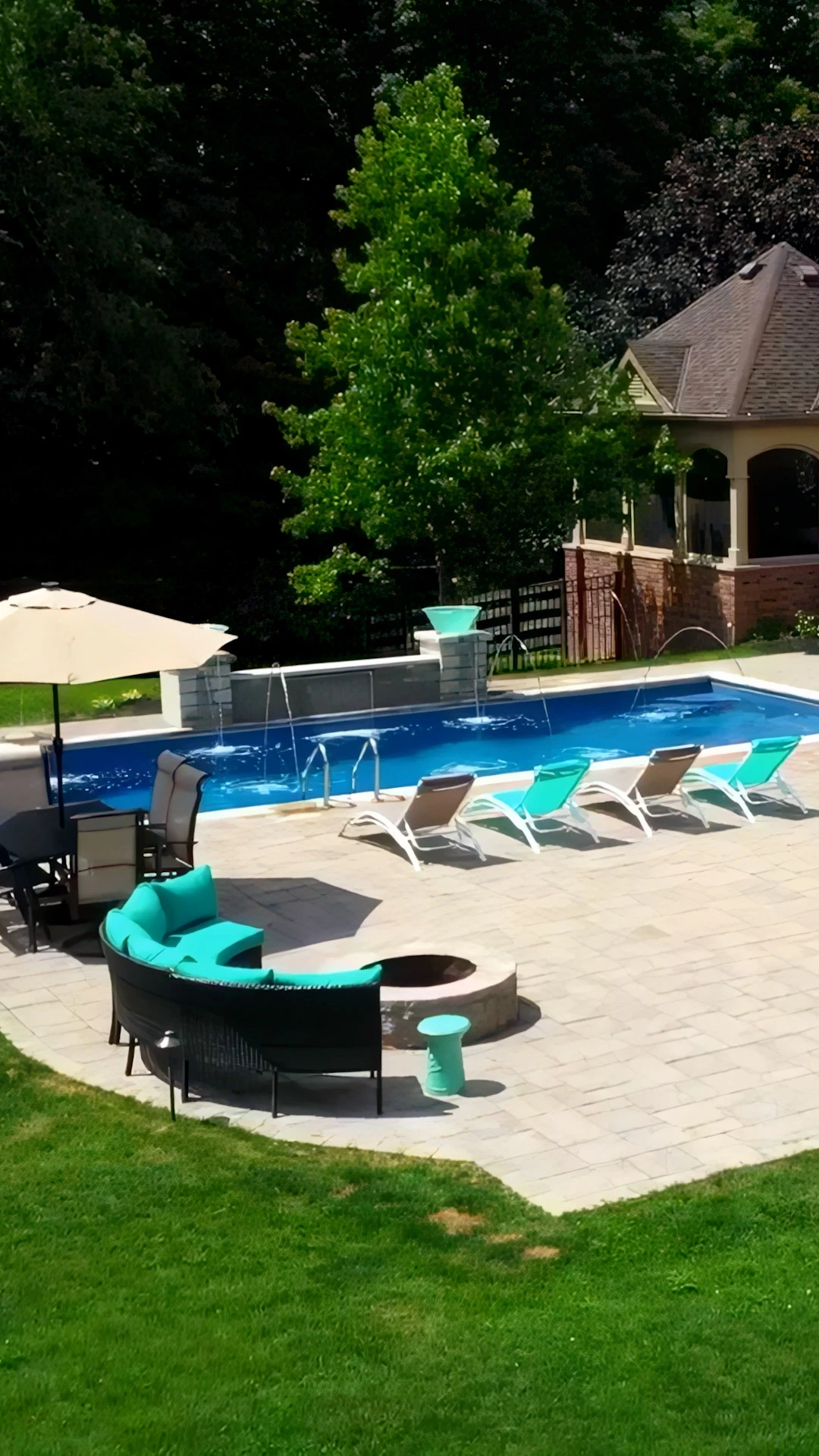 Finished custom pool with travertine terraced deck integrating with natural grade on a Milton, GA equestrian property