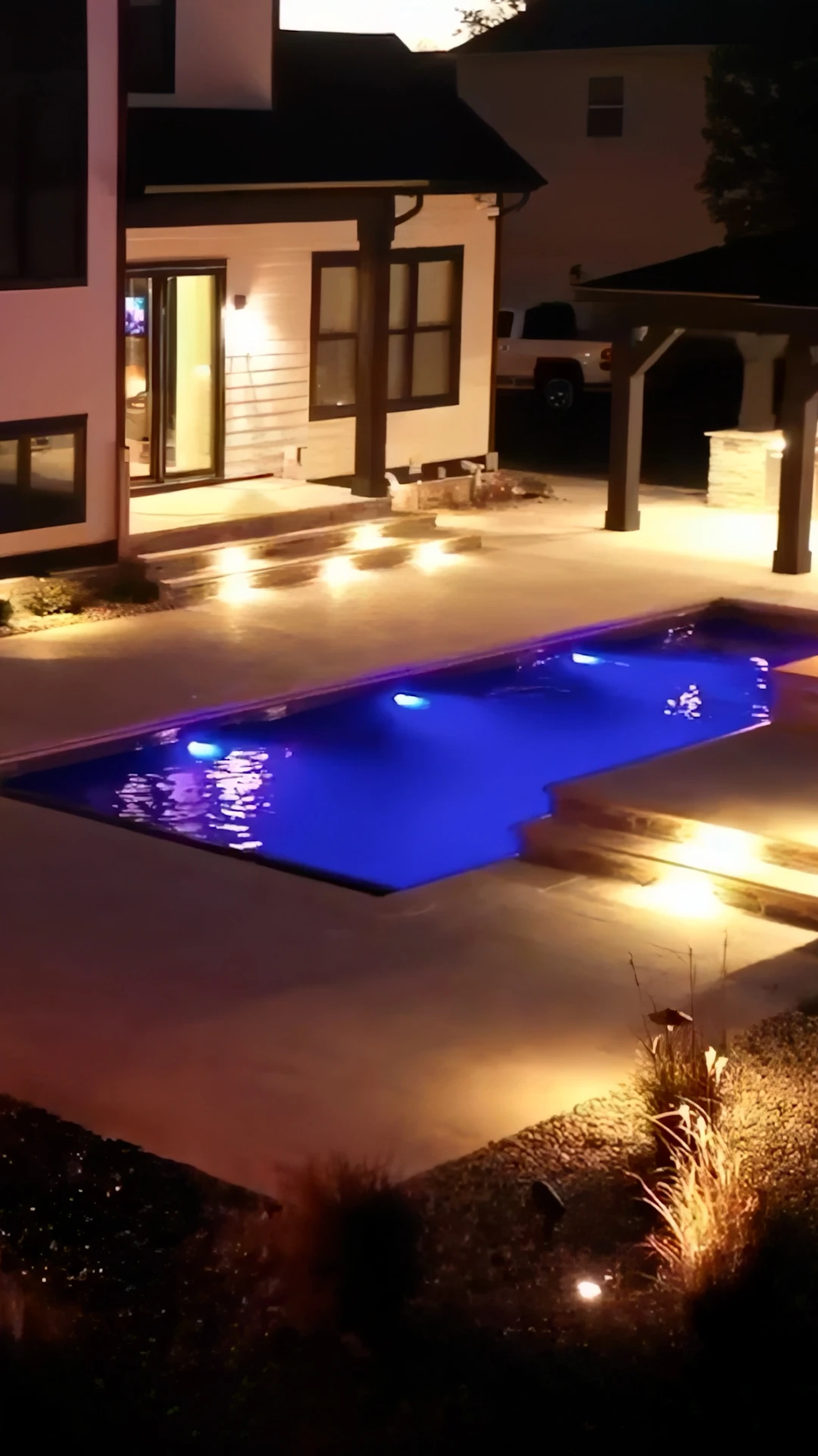 Completed custom pool with integrated retaining wall and stone patio on a Milton GA estate property