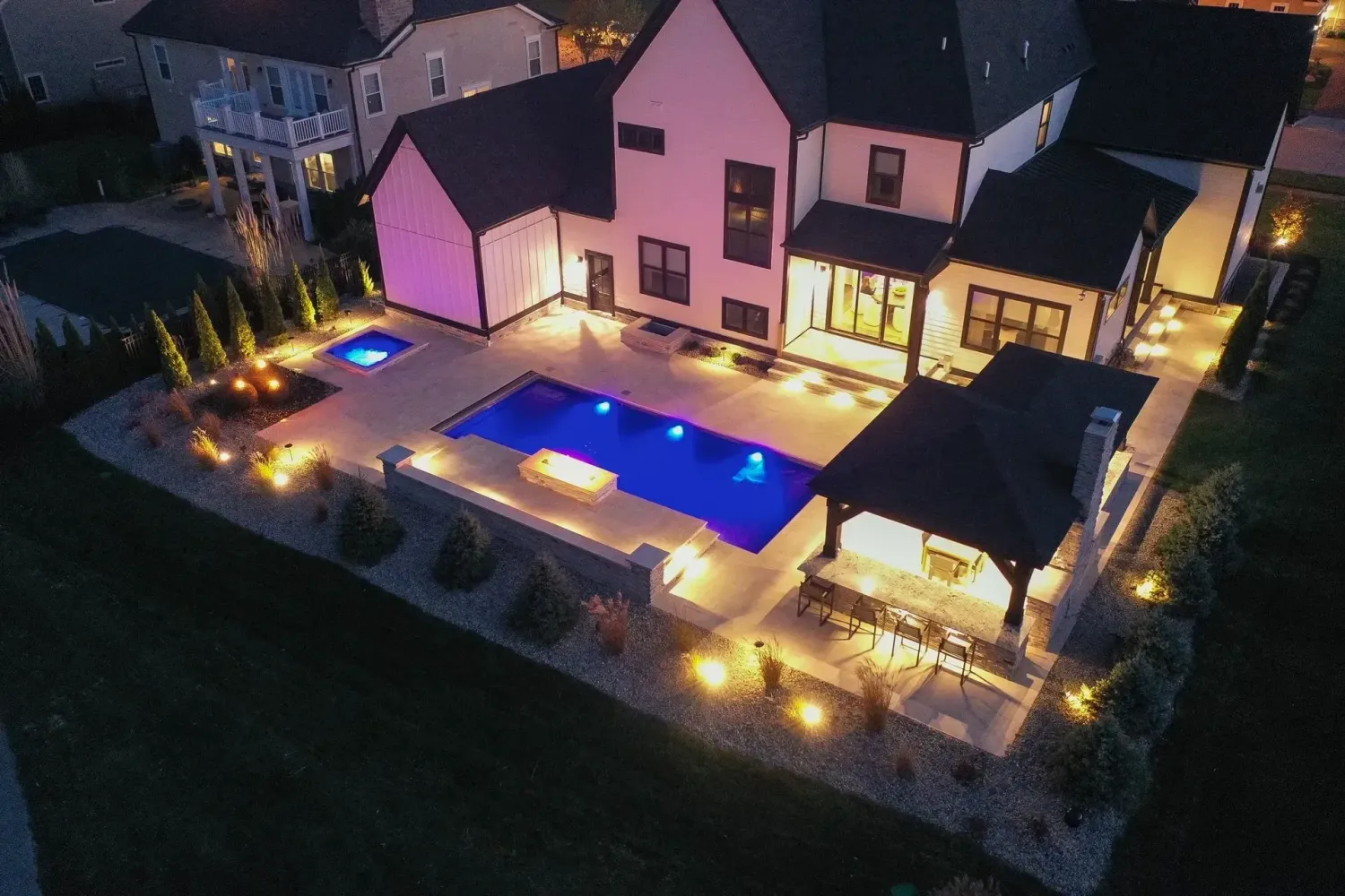Close-up of step-riser LED strip lighting under stone tread, custom pool deck build Milton, GA