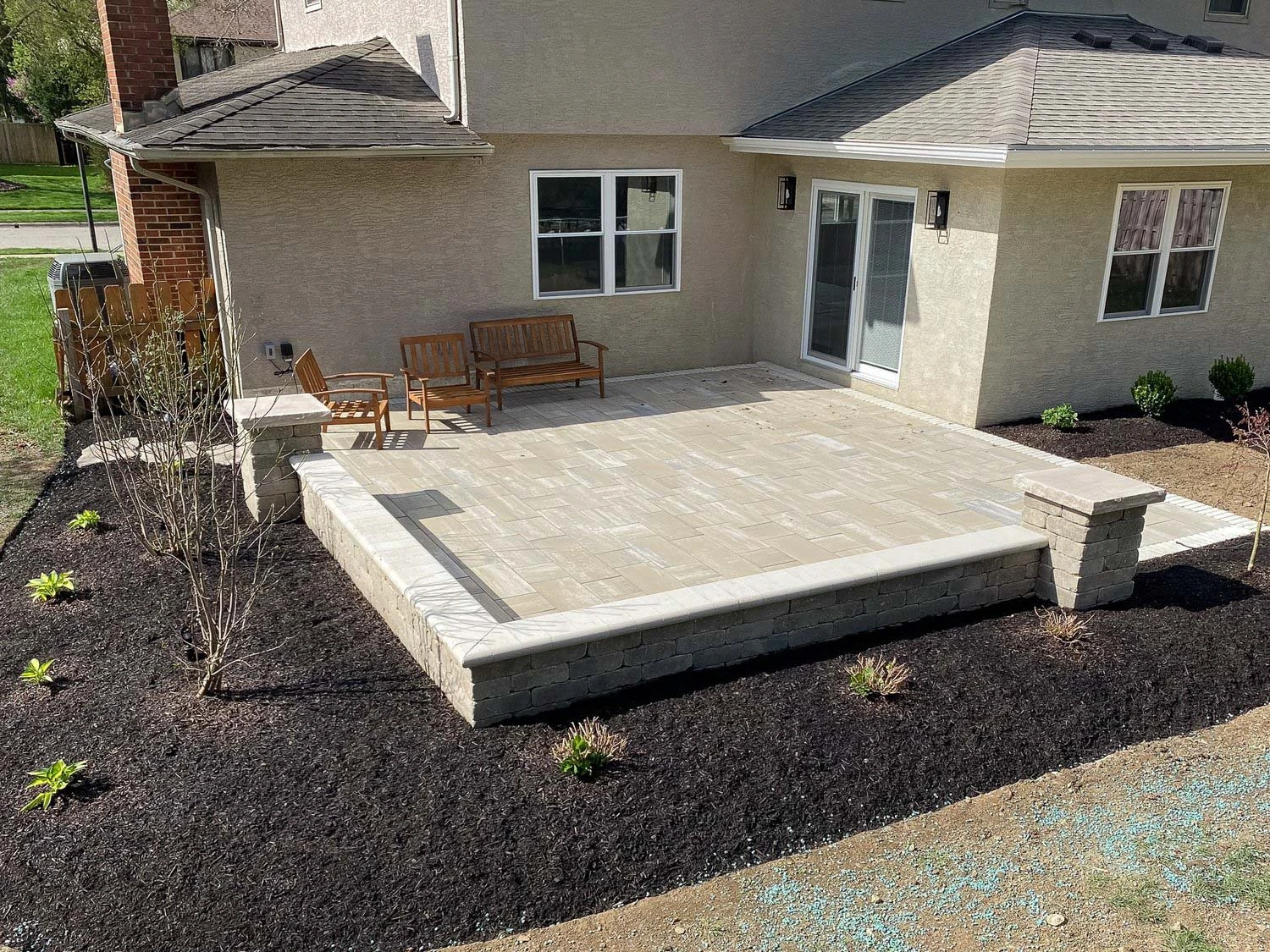 Clarkston GA backyard hardscape with paver patio, seating wall, and integrated landscape steps mid-project
