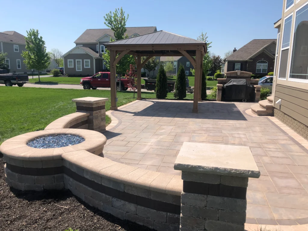 Minimalist wood-look paver patio with stainless-look rectangular gas firepit and charcoal block base — hardscape design and construction in Clarkston, GA by Primetime Pools.