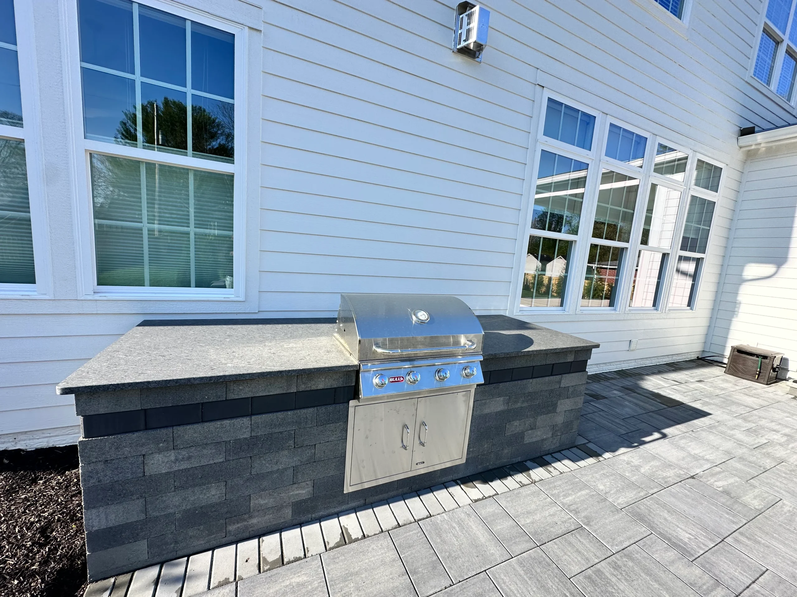 Clarkston GA hardscape patio installation showing the bond between paver field and pool deck under construction