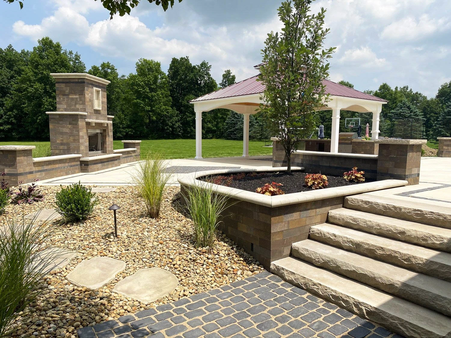 Finished hardscape and retaining wall integration with patio, stairs, and landscaping on a graded Dawsonville, GA mountain lot