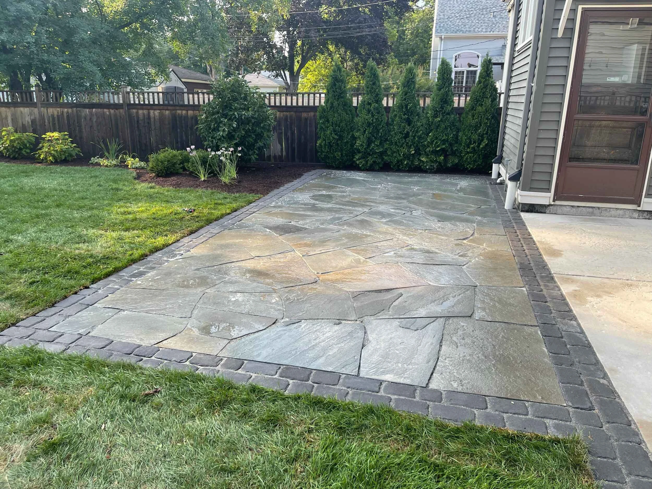 Hardscape stone steps and terrace transition between two pool deck levels on a Milton, GA estate build