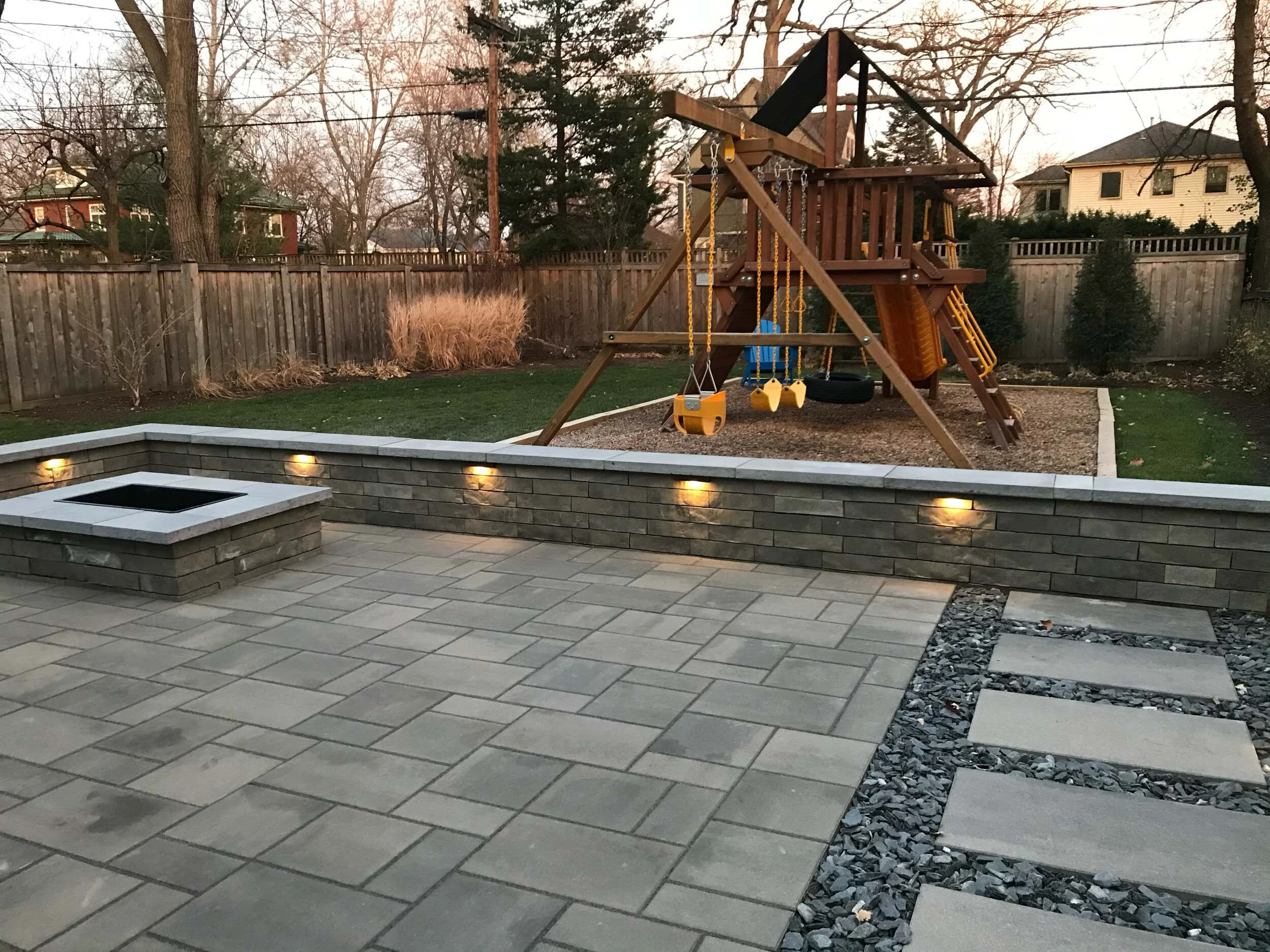 Stone retaining wall integrated with estate landscape and pool deck — Milton, GA