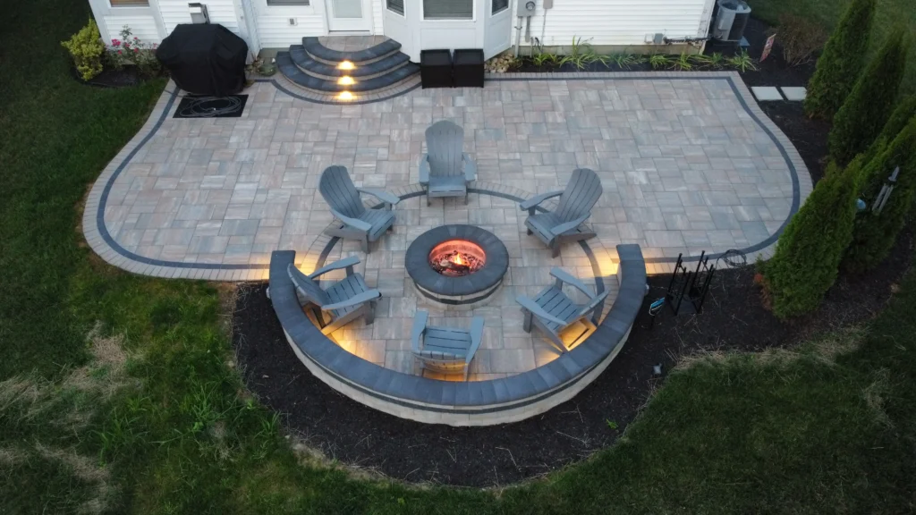 Flagstone patio with tight joints and charcoal brick soldier border along craftsman home — hardscape design and construction in Suwanee, GA by Primetime Pools.