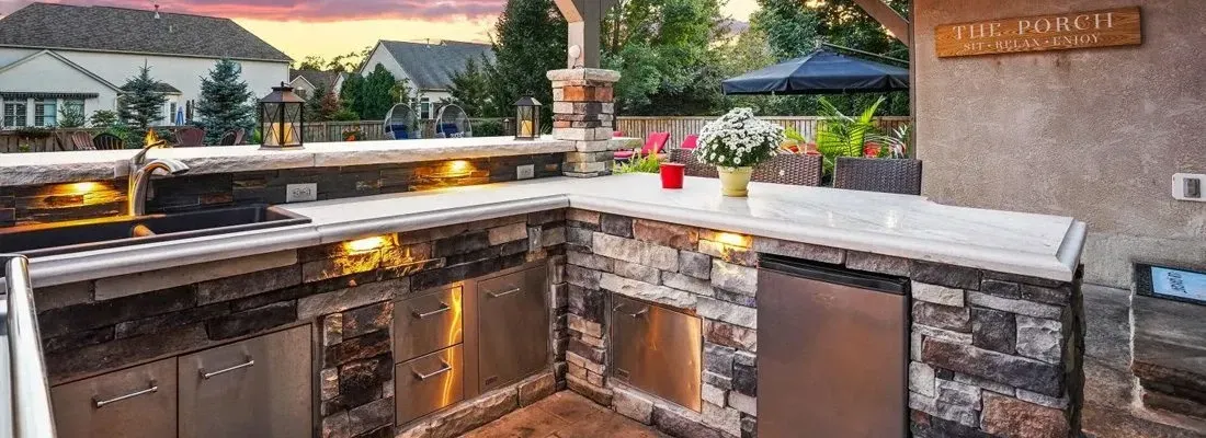 Built-in Big Green Egg and side-burner module in a Milton, GA estate outdoor kitchen