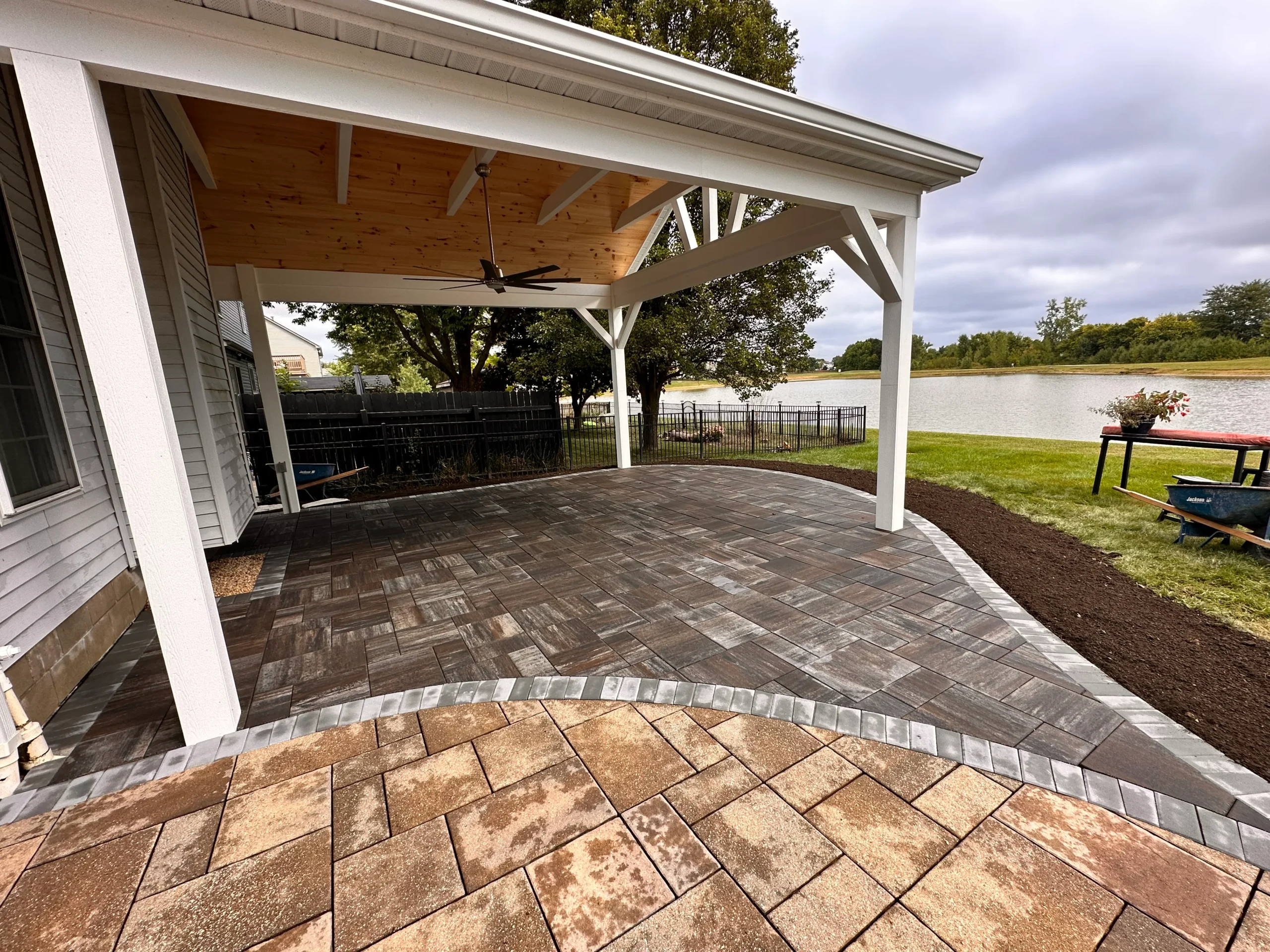 Techo-Bloc paver patio installation with tight perimeter cuts near pool coping edge, Alpharetta GA