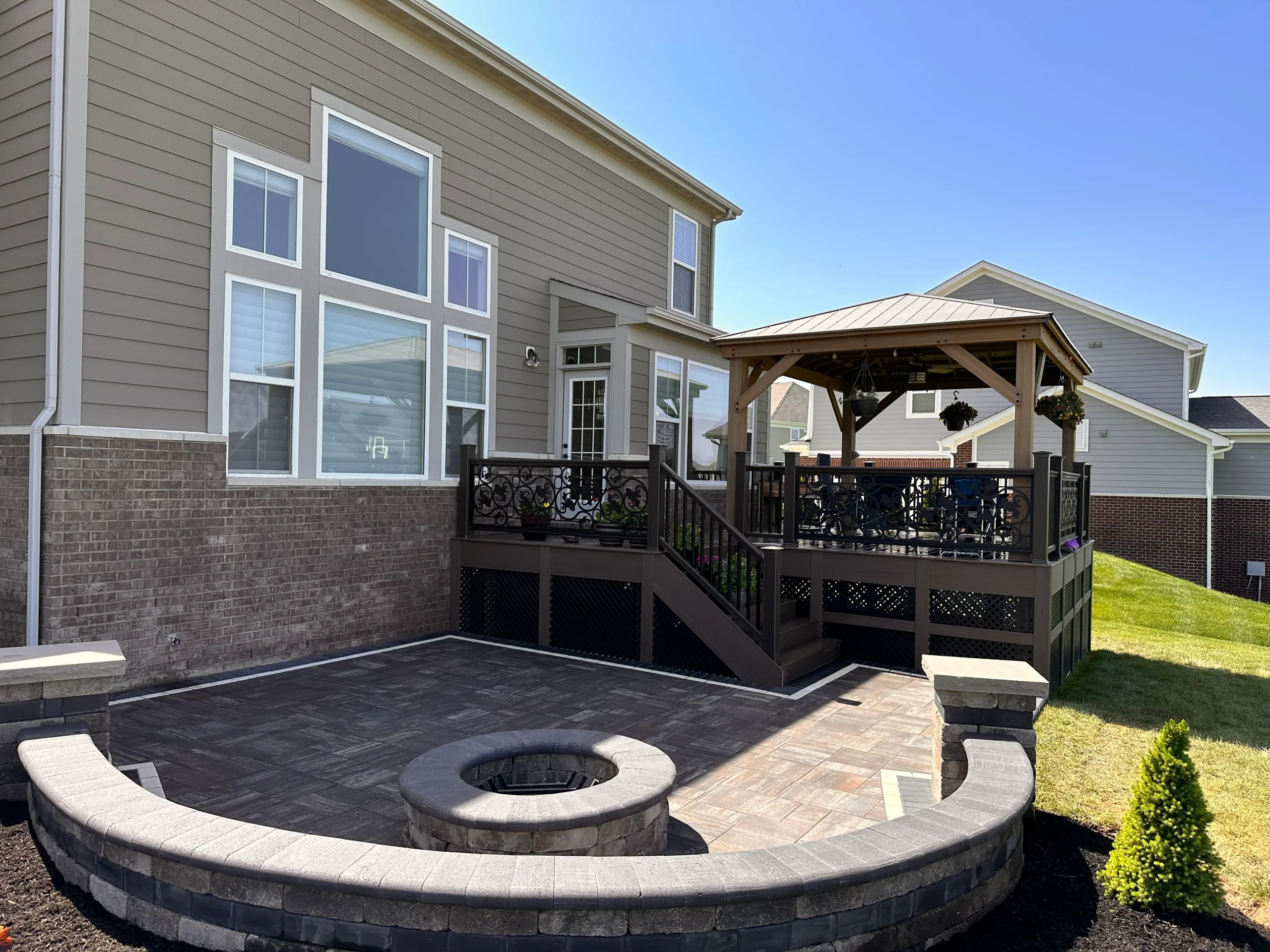 Wide view of travertine pool deck and paver patio with pool steps visible in a Clarkston GA backyard renovation