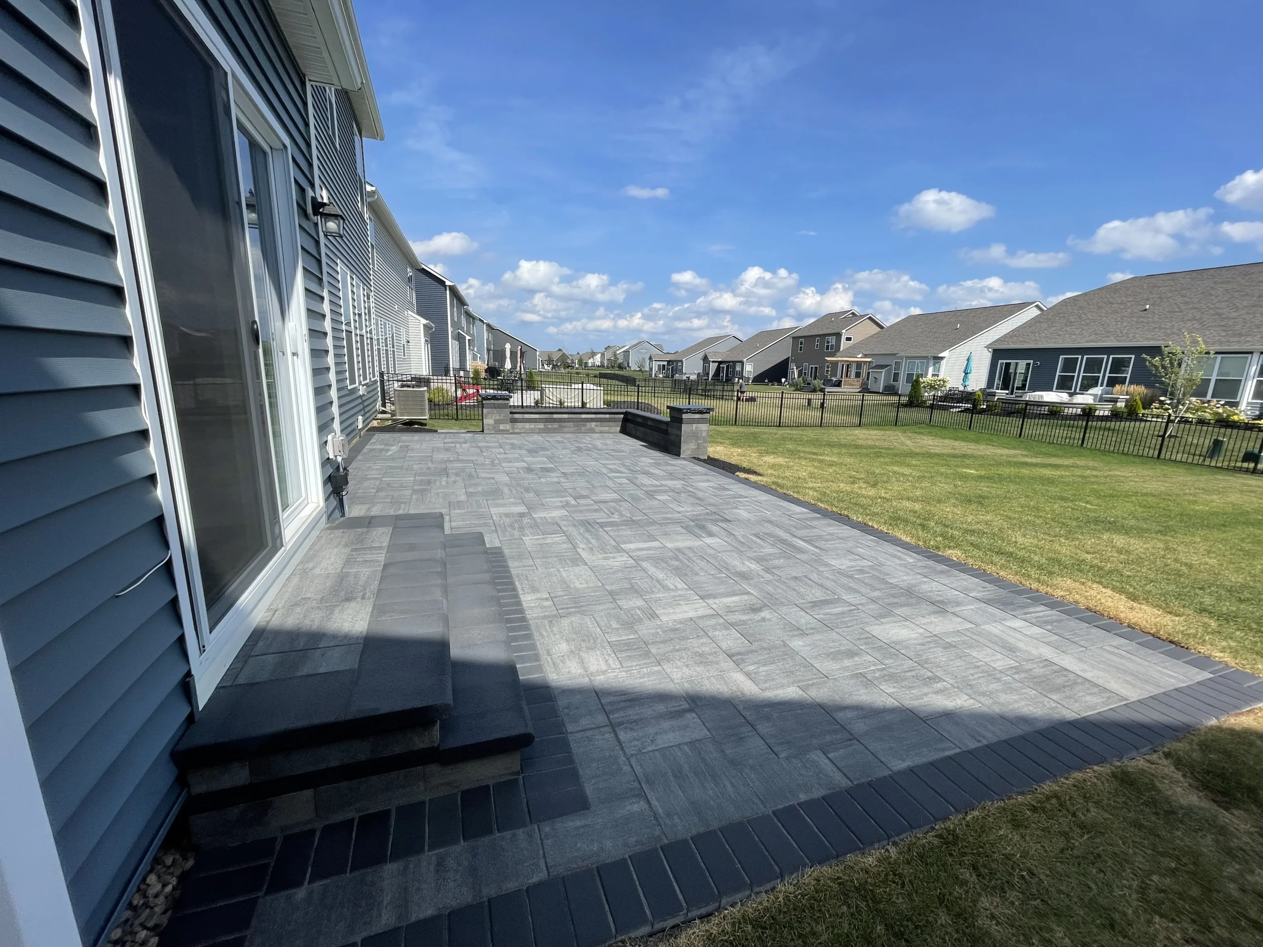 Multi-toned paver field and pool deck showing surface color variation in Forsyth County, GA