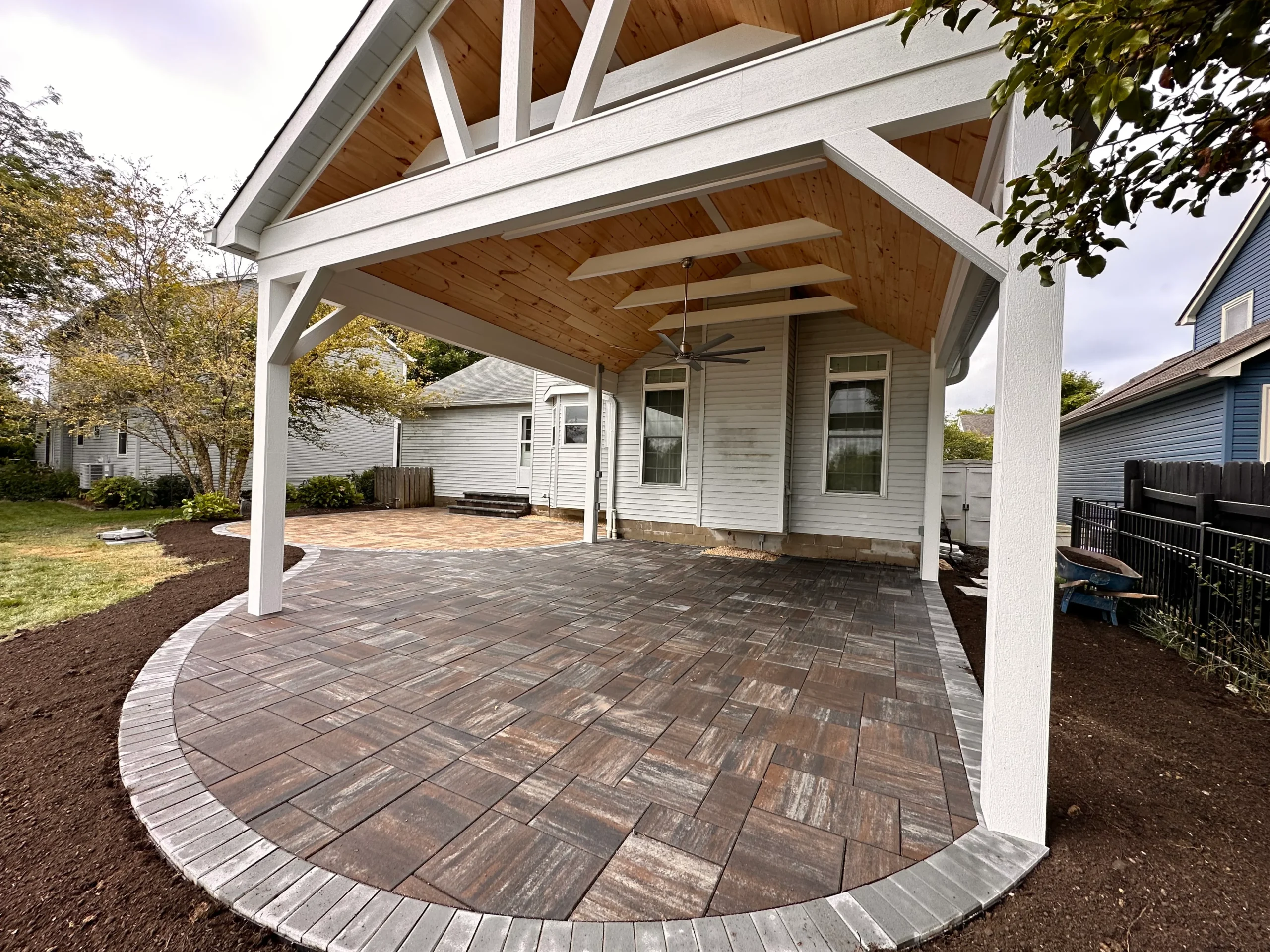 Large Techo-Bloc paver patio installation on a Milton, GA estate lot with curved border and open lounging zone