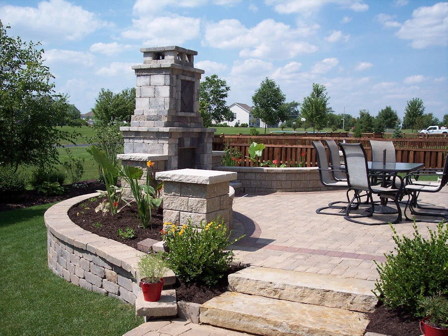 Mixed paver pool deck in Clarkston GA showing limestone and bluestone elements around custom pool with coping detail