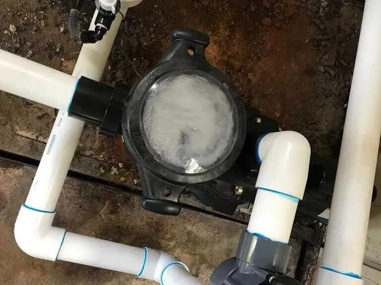 Technician assessing aged pool equipment pad in Dacula, GA — pump, filter, and heater past service life