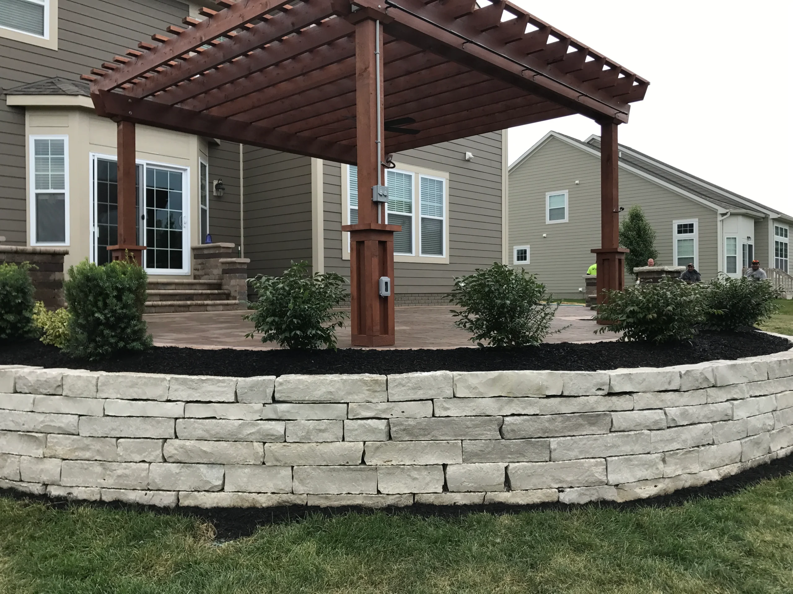 Segmental retaining wall in Clarkston GA backyard showing proper base course and geogrid drainage profile