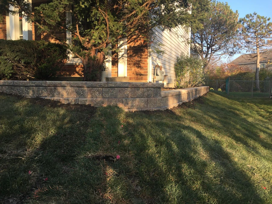 Finished Cumming GA retaining wall with pool deck and integrated steps showing patina and stone texture.