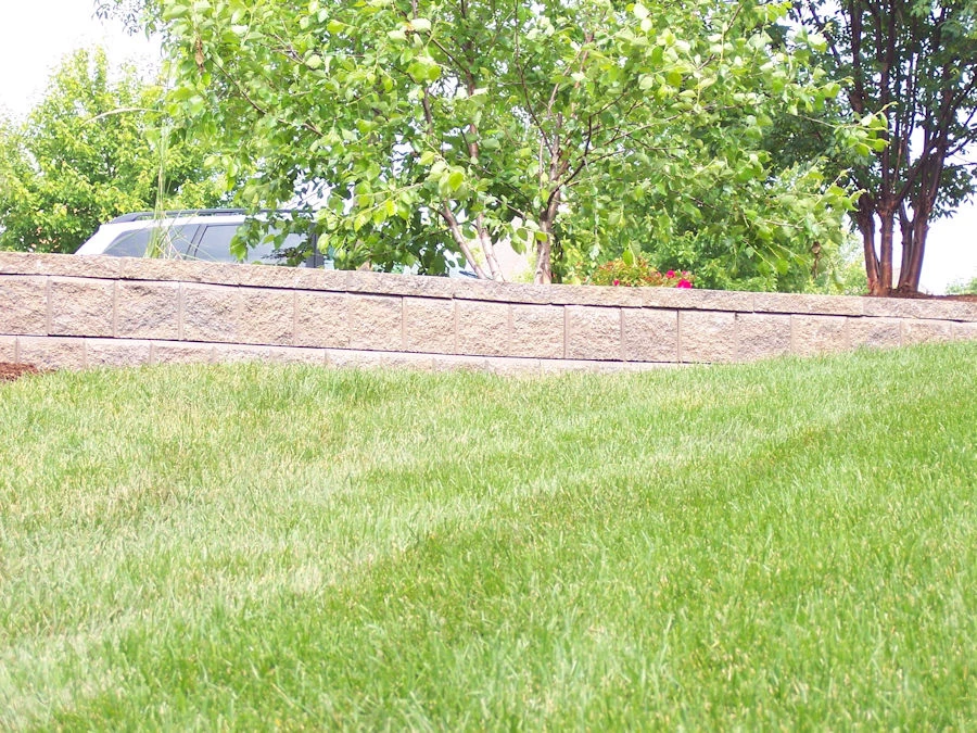 Natural stone veneer retaining wall with integrated landscape steps East Cobb luxury home Marietta Georgia