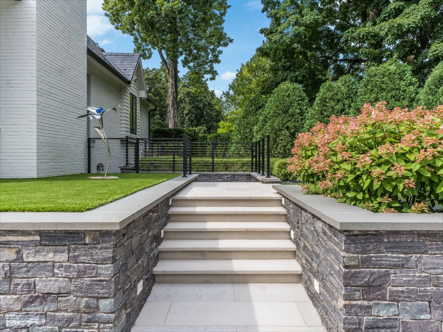 Segmental block retaining face with drainage gravel and perforated pipe at base on a Milton, GA pool deck terrace