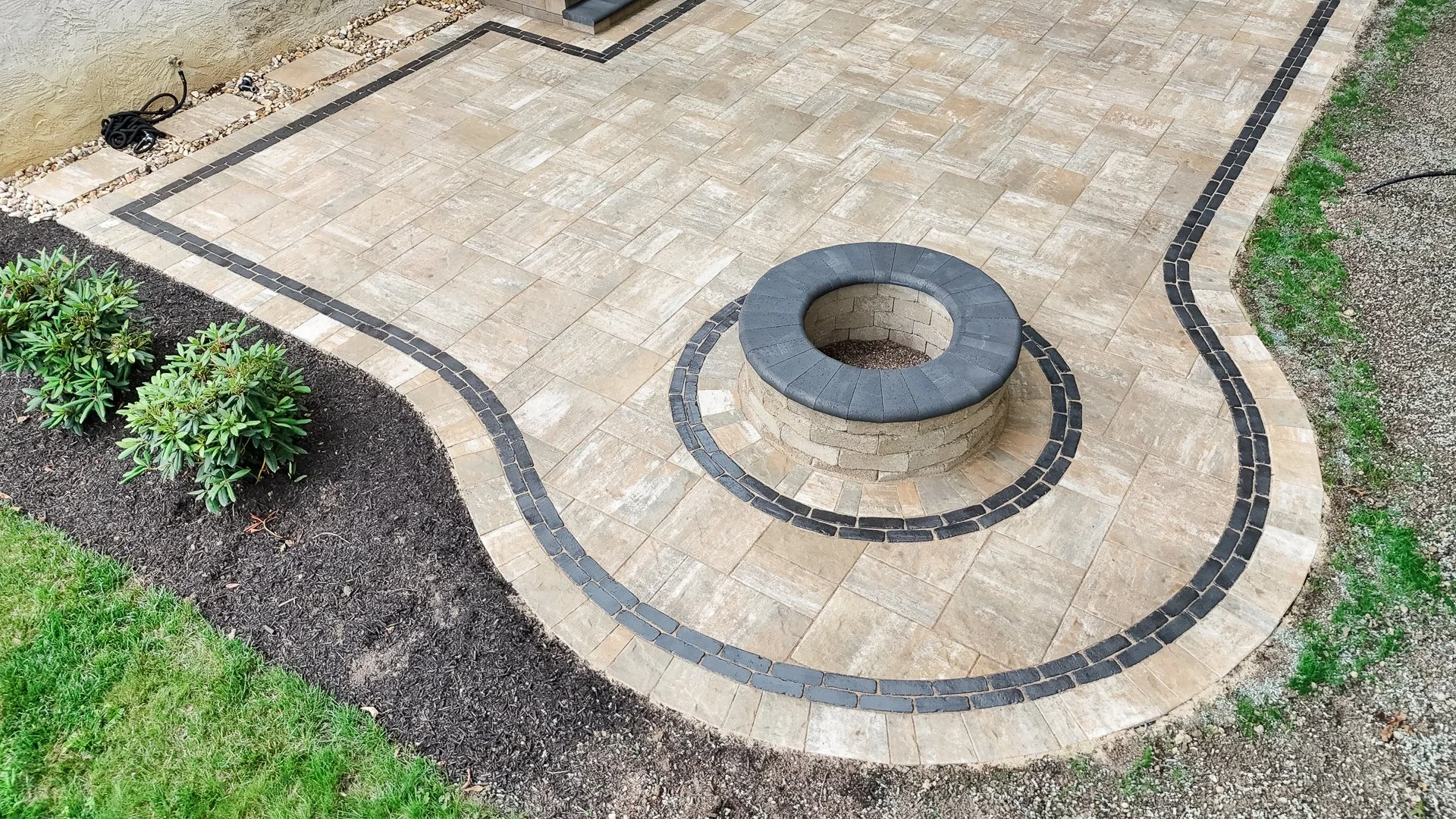 Paver patio with integrated gas firepit and seating wall in Hamilton Mill, Dacula, GA