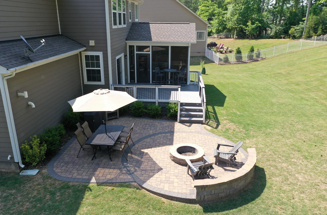 Outdoor fireplace in covered pavilion with seating area near pool in Marietta, GA