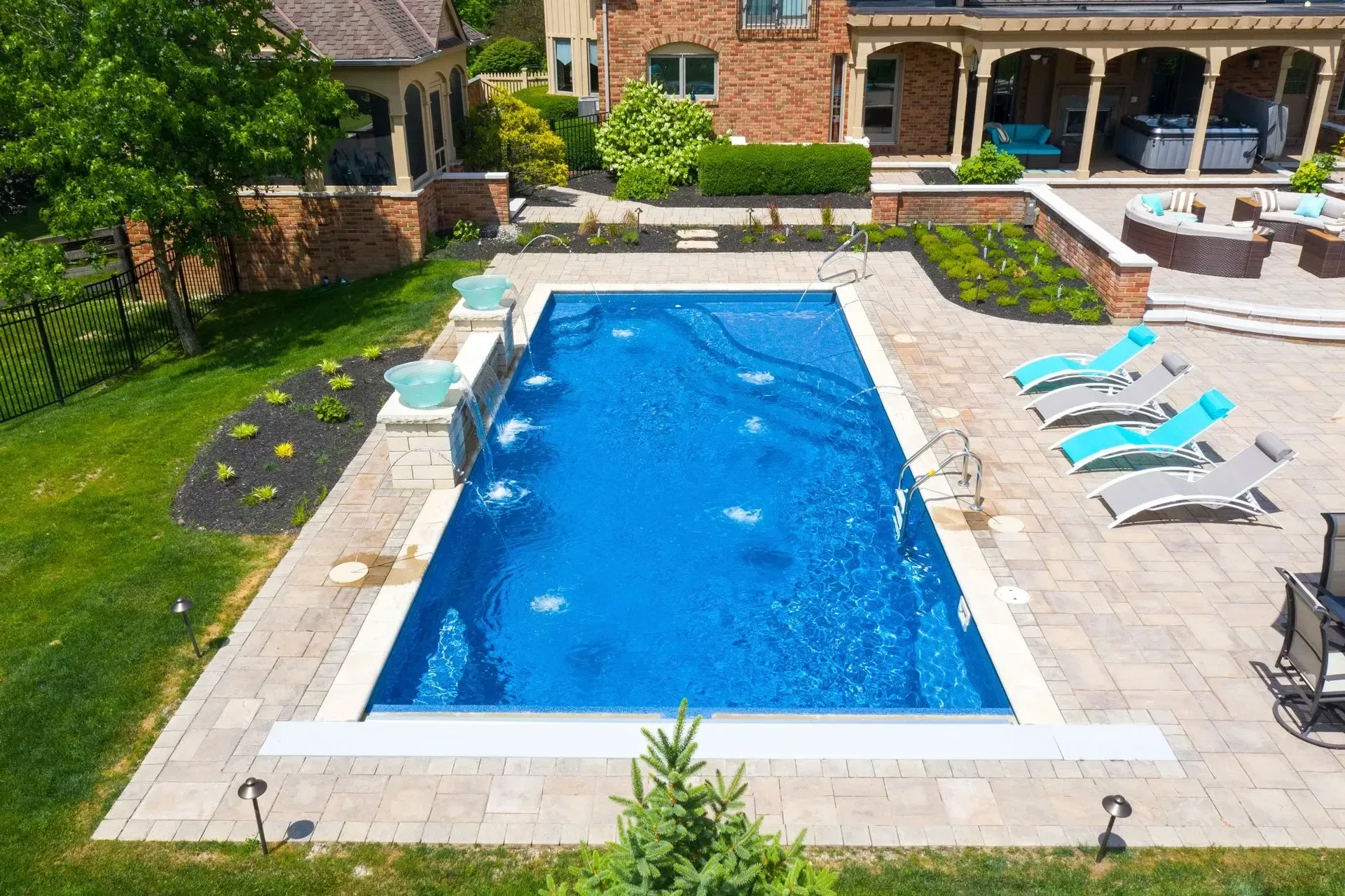 Natural stone pool deck with pavers set in French pattern around the pool edge in Dacula, GA