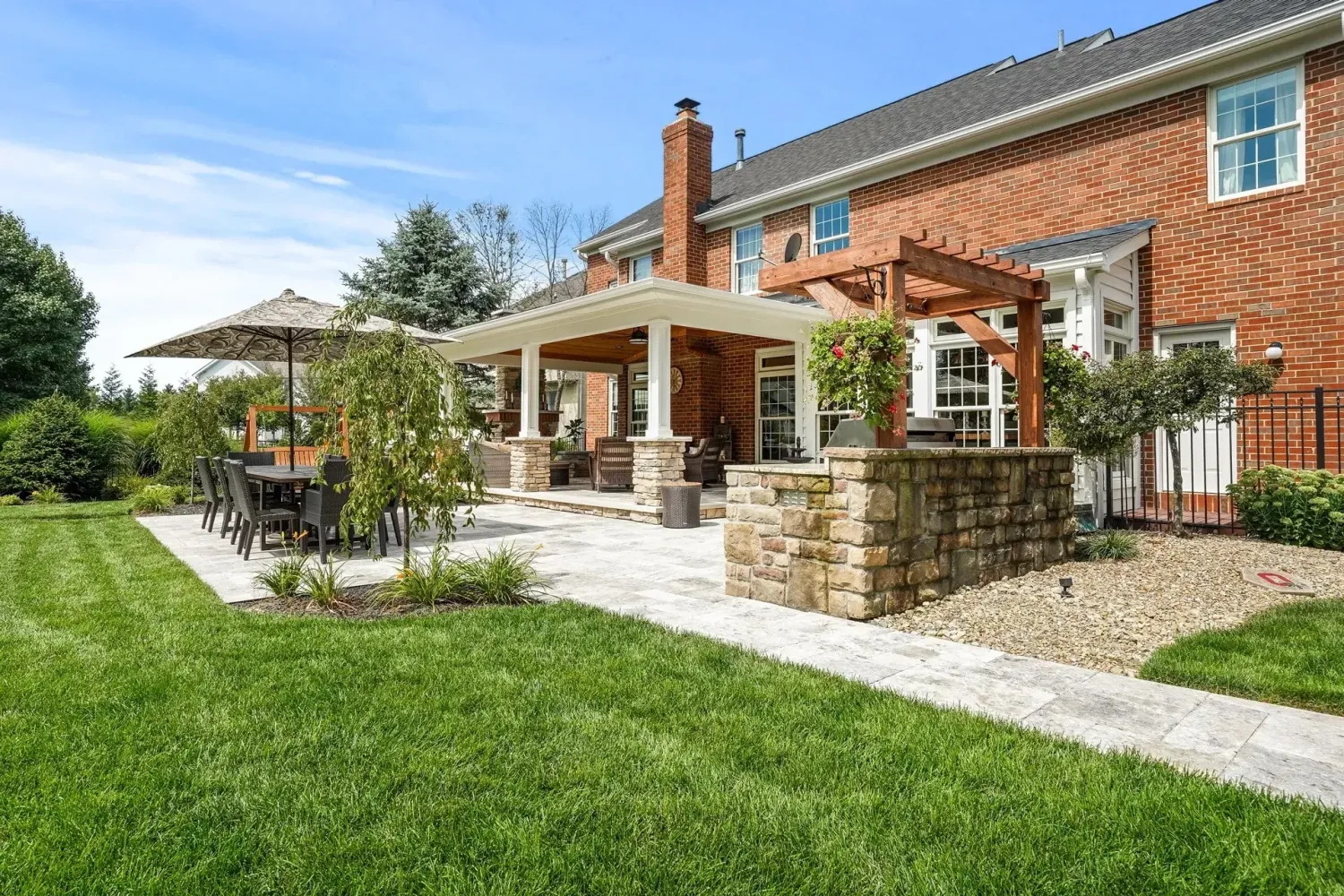 Motorized aluminum louvered pergola in a Cumming, GA backyard with pavers and landscape lighting