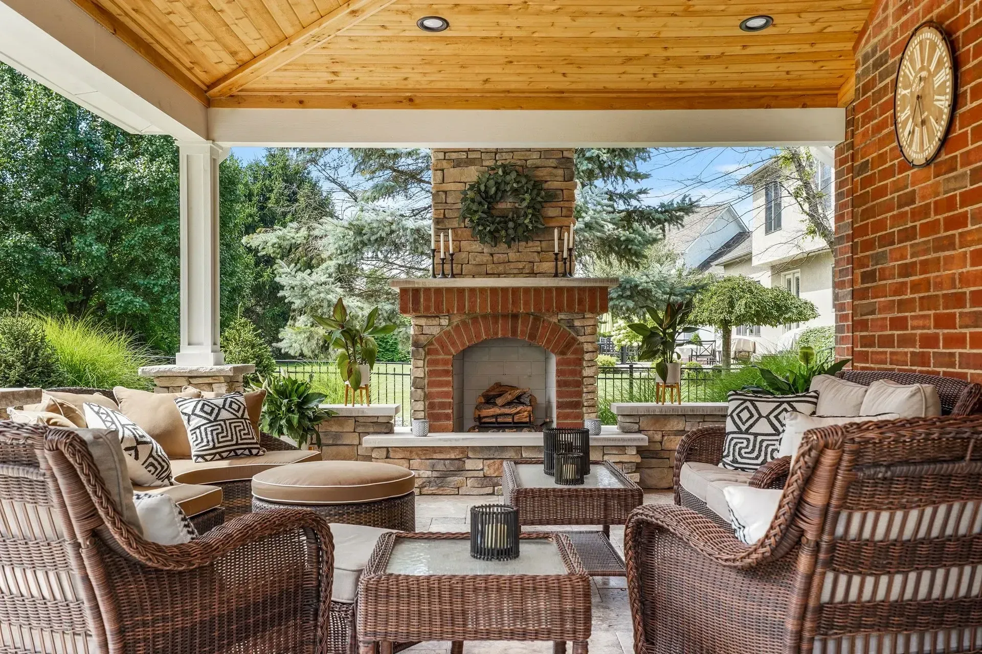 Backyard pergola with stainless outdoor kitchen components and stone veneer base in Dacula, GA