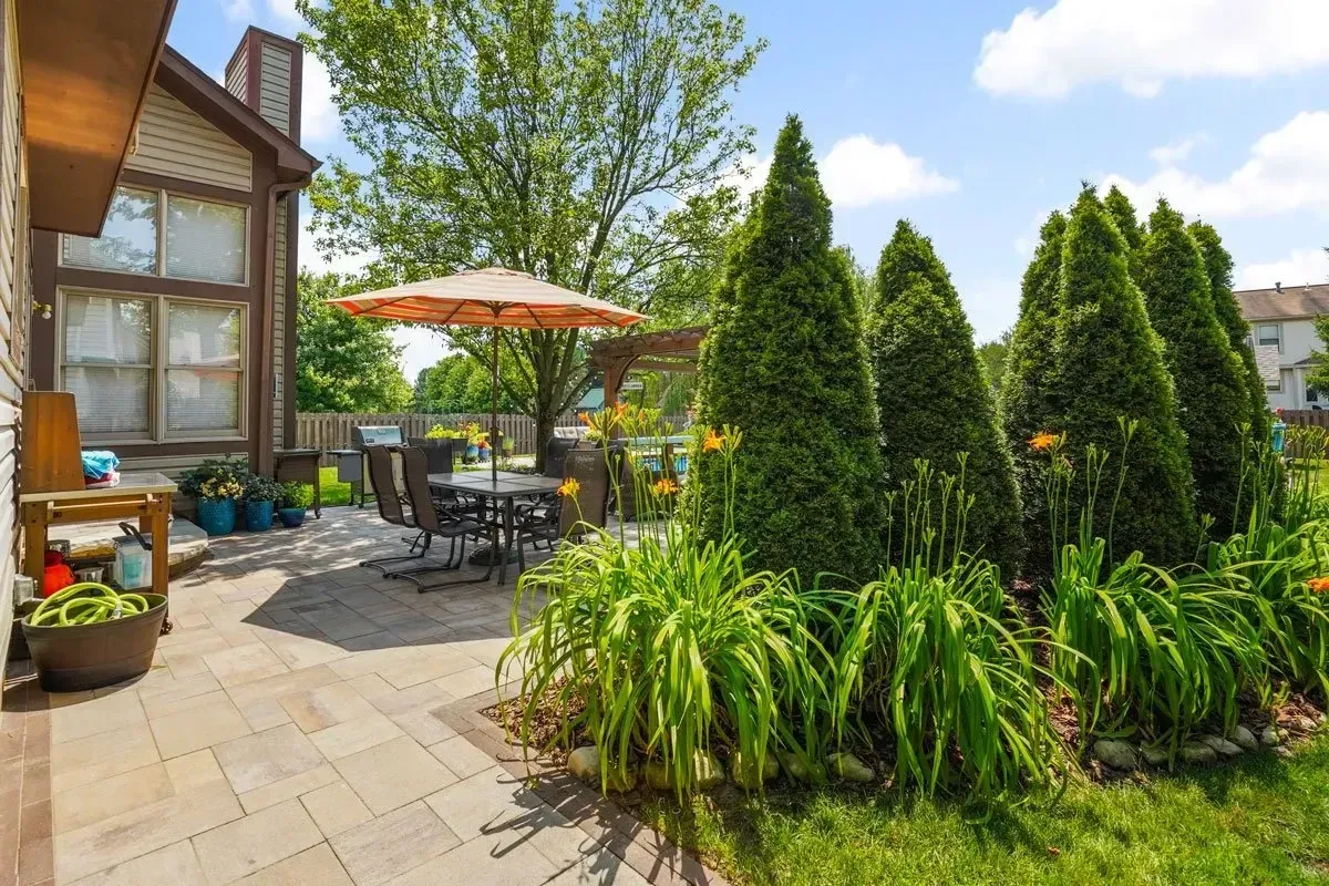 Solid-roof timber pavilion over stone-base outdoor kitchen in Marietta, GA