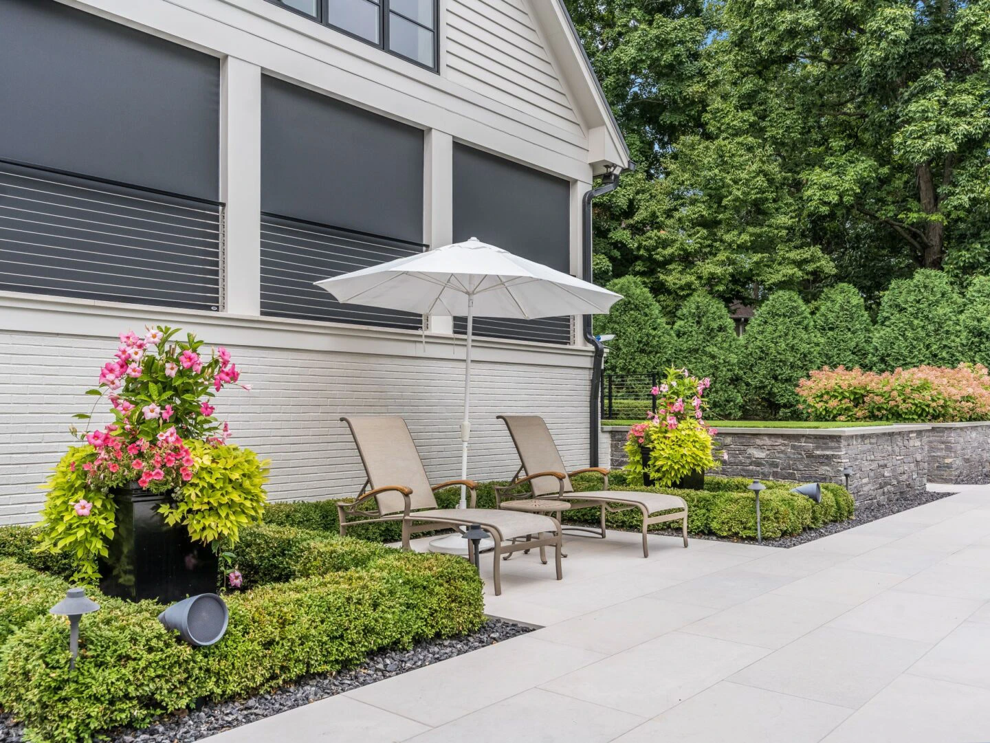 Attached aluminum louvered pergola engineered into rear wall of a Laurel Springs custom home in Suwanee, GA